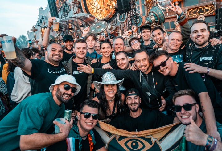 Group of people smiling and waving in Tomorrowland Academy.